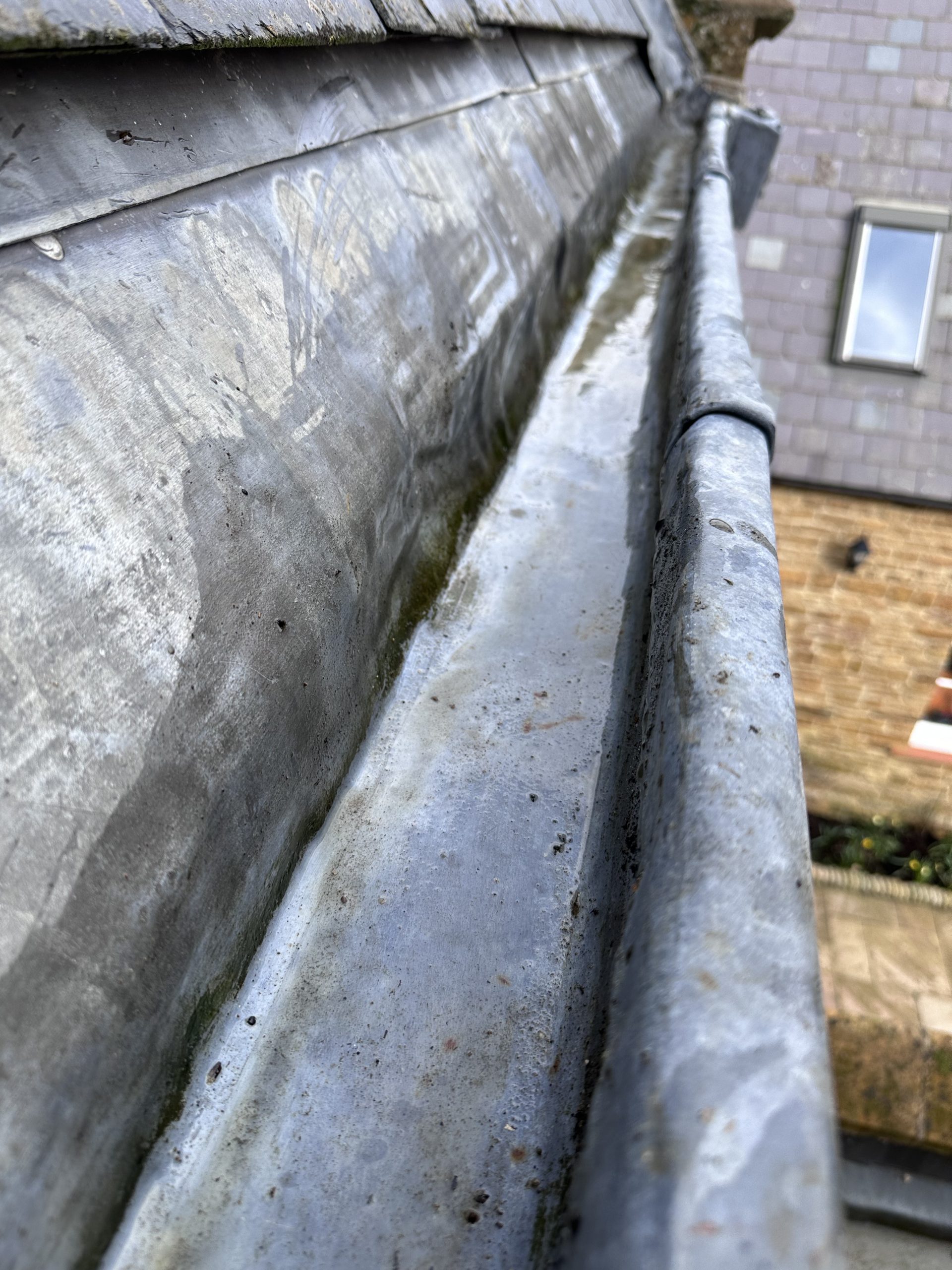 Cleaned gutter channel ensuring proper rainwater flow